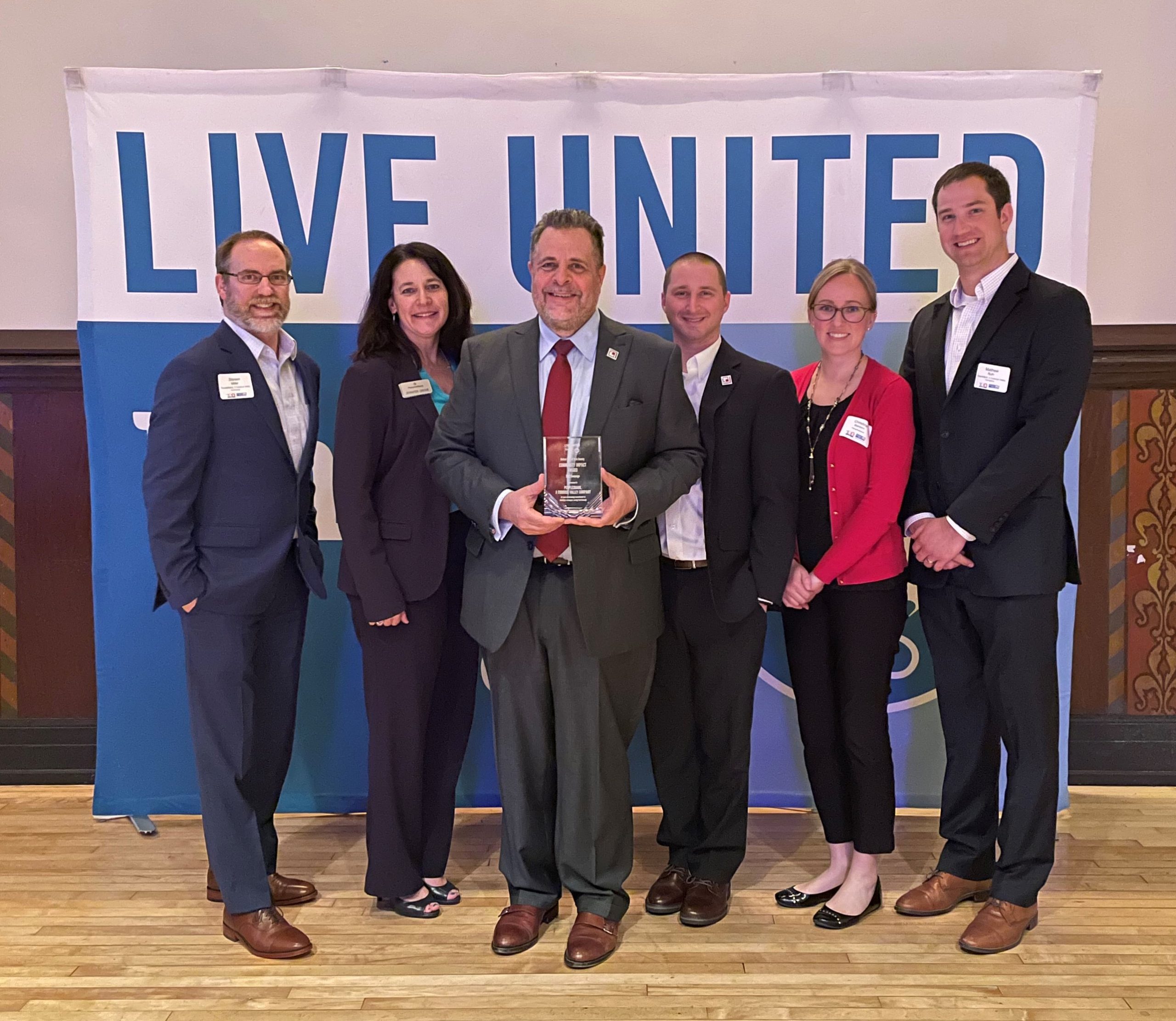 group of PeoplesBank associates accepting United Way award